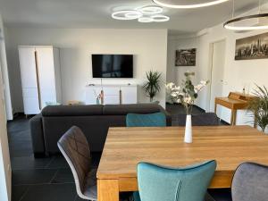 a living room with a table and a couch at Modern Apartment Mainz by PMA in Mainz