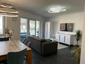 a living room with a couch and a table at Modern Apartment Mainz by PMA in Mainz