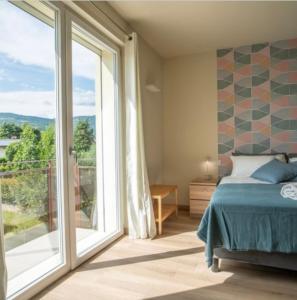 a bedroom with a bed and a large window at Monolocale Moderno Valpolicella Verona - Agni in San Pietro in Cariano