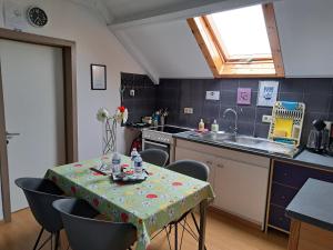 a kitchen with a table and chairs and a sink at Claire de Meuse Cozy apartment Detox with river and hills in Anhée