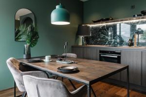 a dining room with a wooden table and chairs at Exklusive Design Appartement Palm Paradise Neubau in Pfungstadt