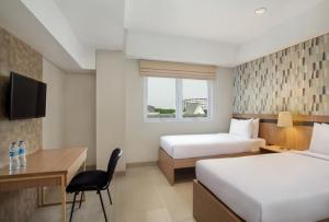 All Nite and Day Hotel Alam Sutera में एक कमरे में एक या कई बेड