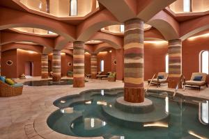 a hotel lobby with a pool and columns at Steigenberger Golf Resort El Gouna in Hurghada