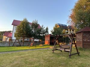 een park met een schommel in het gras bij Готель Едельвейс in Skhidnitsa