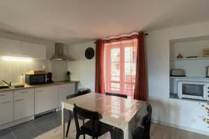 a kitchen with a table and chairs and a window at Gîte NO 9 in Neufchâteau