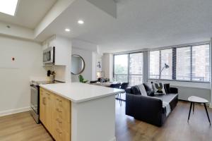 uma cozinha e sala de estar com um sofá e uma mesa em Unique Luxury Apt with Rooftop @Pentagon City em Arlington