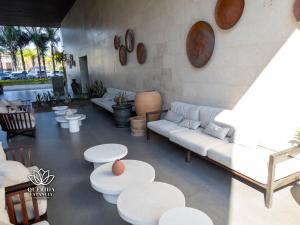 a living room with white couches and tables and chairs at Beautiful Aria Ocean 401 QueridaEstancia in Nuevo Vallarta 