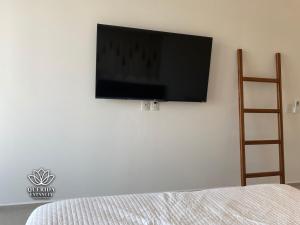 a flat screen tv hanging on a white wall at Beautiful Aria Ocean 401 QueridaEstancia in Nuevo Vallarta 