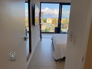 a bedroom with a bed and a large window at Beautiful Aria Ocean 401 QueridaEstancia in Nuevo Vallarta 