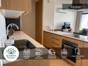 a kitchen with a sink and a stove top oven at Beautiful Aria Ocean 401 QueridaEstancia in Nuevo Vallarta 