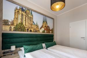 a bedroom with a large painting above a bed at Hotel Garni " Am Domplatz" in Erfurt