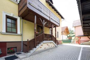 a house with a wooden porch with a balcony at Villa Ganzstein in Mürzzuschlag