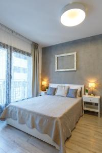 a bedroom with a large bed and a large window at K40 Romantic Deluxe Studio In the City Center in Budapest