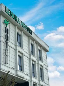 a white building with a sign on top of it at Lenora Airport Hotel & İstanbul Airport in Arnavutköy