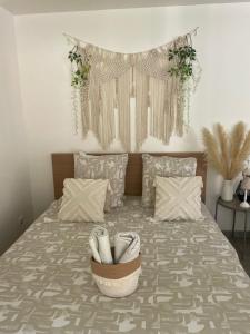 a bedroom with a bed with shoes in a basket at Grand Studio neuf in Aulnay-sous-Bois