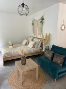 a living room with a couch and a coffee table at Grand Studio neuf in Aulnay-sous-Bois