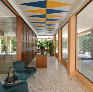 a lobby with a blue and yellow ceiling at Casa Brivio in Milan