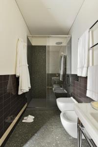 a bathroom with two sinks and two toilets at Casa Brivio in Milan