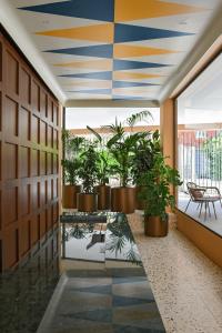 a lobby with plants in pots on a table at Casa Brivio in Milan