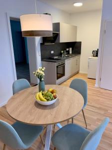 a table with a bowl of fruit on it in a kitchen at Apartment Brauselay in Cochem