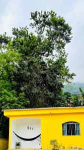 a yellow building with a smile painted on it at Carvalho de Paquetá in Rio de Janeiro