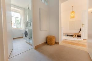 a hallway with a door leading to a living room at Gran.Suite - Central Station in Sankt Pölten