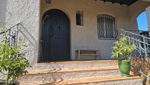 un portico di una casa con una porta e una sedia di Villa Farniente a Sète