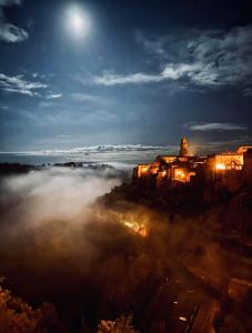 a view of a city in the fog at night at Neoclassico by Tiziana Monaldi in Pitigliano