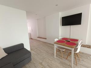 a living room with a table and a couch at Tomarhousing - 37 Old Town in Tomar