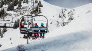 um grupo de pessoas a andar de teleférico na neve em Residence Nube D'Argento em Sestriere