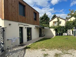 a building with a grass yard in front of it at Sara in Aulnay-sous-Bois