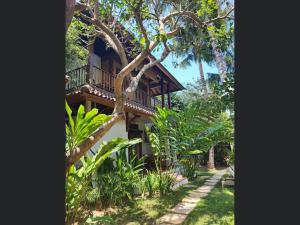 a house with a balcony in the trees at Villa Jati Mangsit in Senggigi 