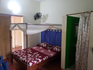 A bed or beds in a room at Hotel Le Petit Paradis