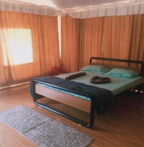 a bedroom with a bed with a canopy at Trident Jungle Stay in Dandeli