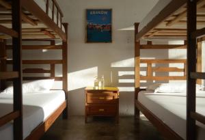 A bed or beds in a room at Playa del Ritmo Beach Hostel & Bar - Adults Only