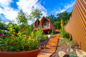 um jardim com uma cerca de madeira e uma casa em Parádka - Toscana Villa em Parád