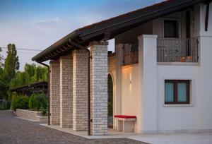 a building with a balcony with a bench on it at Il Filo Rosso B&B in Abano Terme