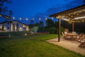 a backyard with a table and a pergola at night at Il Filo Rosso B&B in Abano Terme