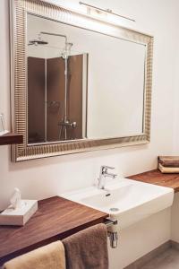 a bathroom with a sink and a large mirror at Villa Thermale in Unterlamm