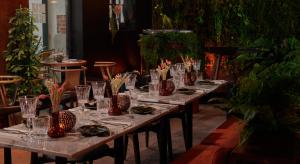 a long table with glasses and plates of food at Kube Hôtel Paris in Paris