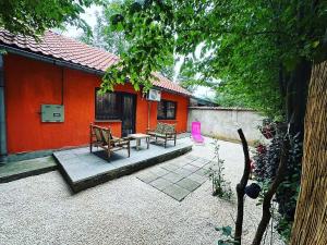 a patio of a house with a table and benches at Hedonist Spa Jacuzzi Sarajevo in Sarajevo