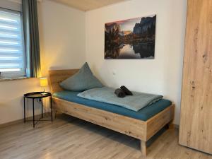 a bed in a room with a picture on the wall at Gästehaus Trockau in Pegnitz