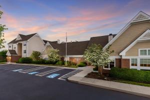 a parking lot in front of a house at Residence Inn Hartford Rocky Hill in Rocky Hill