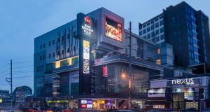 a building with neon signs in a city at night at Best Western Plus Metro Clark in Angeles