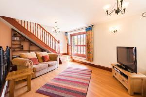 sala de estar con sofá y TV en Super Spacious Country house pet/party friendly., en Newquay