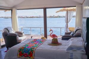 a bedroom with a bed with a pink flamingo on it at Mojsa titicaca lodge in Puno