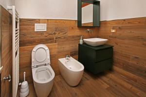 a bathroom with a toilet and a sink at Eydappartamenti in Sauze dʼOulx