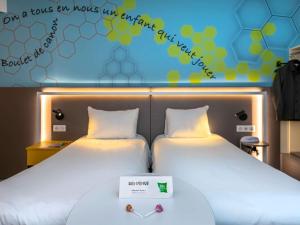 Vuode tai vuoteita majoituspaikassa ibis Styles Strasbourg Stade de la Meinau