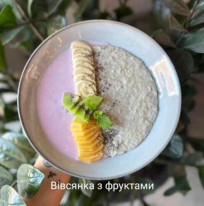 a plate of food with a pink dip and a snack at Apartments Domovik Myru St. 11s/21 in Mukacheve