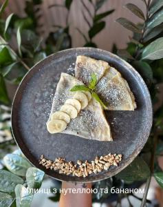 a plate of food with a piece of fish and bananas at Apartments Domovik Myru St. 11s/21 in Mukacheve